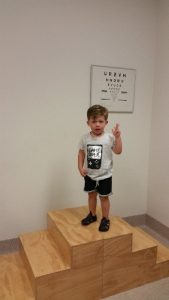 Child standing on a podium